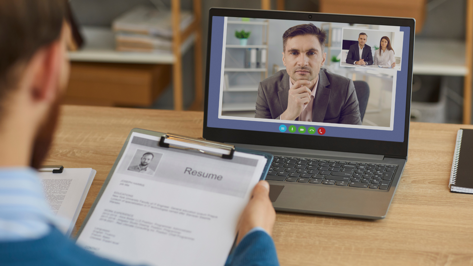 people in a video call seen from a laptop screen