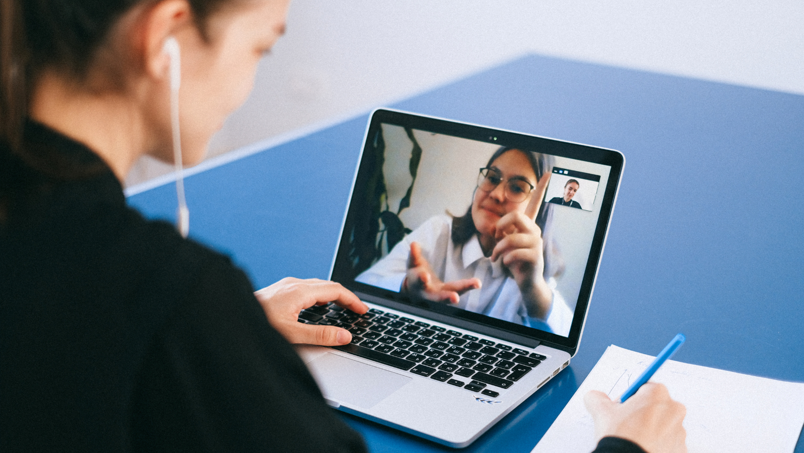 Image of two people on a video call via laptop